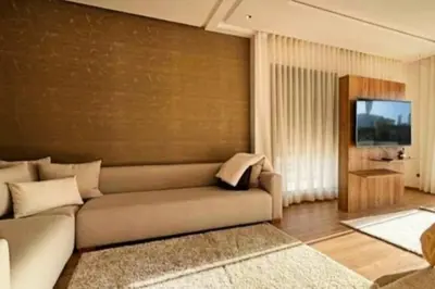 a living room with a couch and a flat screen tv at Poolside Paradise Villa in Dar Ben Abdallah Ben Dehbi