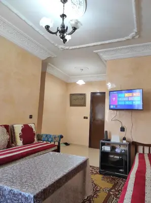 a living room with a couch and a flat screen tv at Appartement familial calme 3 min à Casanearshore in Casablanca