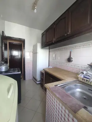 a kitchen with a sink and a refrigerator at Appartement familial calme 3 min à Casanearshore in Casablanca