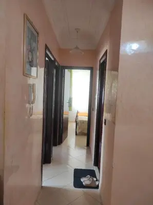 a hallway with a mirror and a room with a bed at Appartement familial calme 3 min à Casanearshore in Casablanca