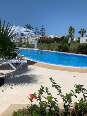 a large swimming pool in a resort at Beach apartment in Dar Bouazza