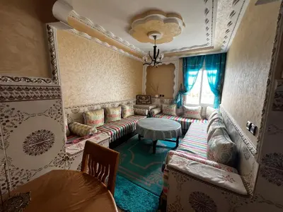 a living room with a couch and a table at Apartment à 1 min de Casanearshore in Casablanca