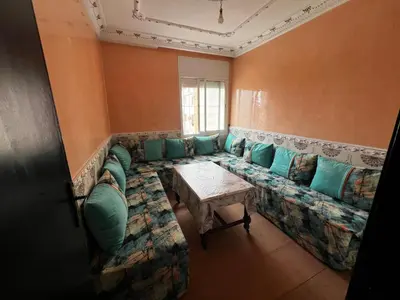 a living room with a couch and a table at Apartment à 1 min de Casanearshore in Casablanca
