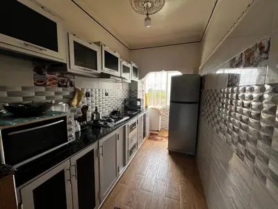 a kitchen with white cabinets and a refrigerator at Apartment à 1 min de Casanearshore in Casablanca
