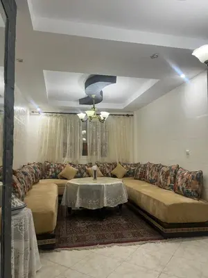 a living room with a couch and a table at Appart meublé 5min de la plage à Bouznika in Bouznika