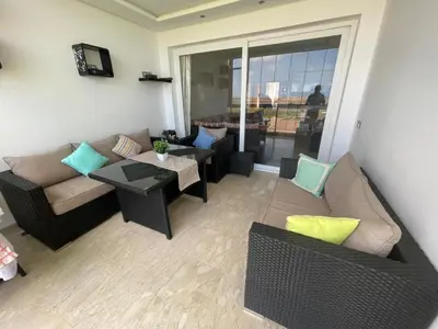 a living room with a couch and chairs and a table at Evasion bouznika in Sidi el Haj Bou Derbala