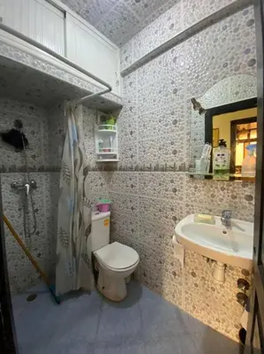 a bathroom with a toilet and a sink at Appartement Neo in Oulad Hamida