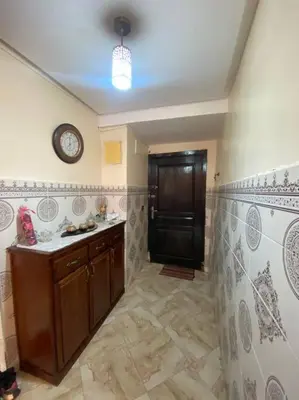 a kitchen with a clock on the wall at Appartement Neo in Oulad Hamida
