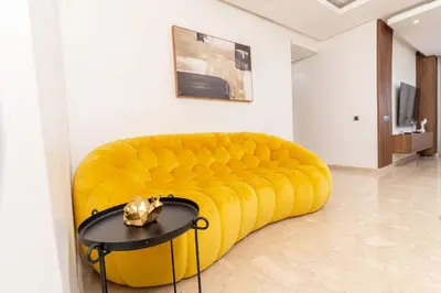 a yellow couch in a room with a table at Casa Streets 3 BR Terrace - AppartAli Luxury Platform in Casablanca