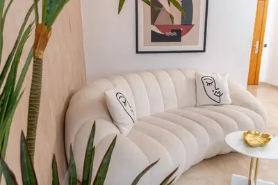 a white couch in a living room with a plant at Penthouse View 2BR Terrace - AppartAli Luxury Platform in Casablanca