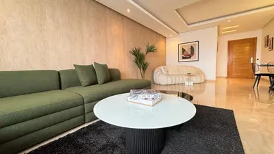 a living room with a green couch and a table at Penthouse View 2BR Terrace - AppartAli Luxury Platform in Casablanca