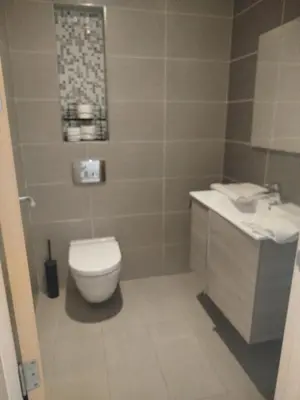 a bathroom with a toilet and a sink at Appartement de luxe Rabat Prestigia in Rabat