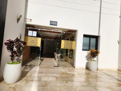 a lobby with two large white vases with flowers in them at Appartement de luxe Rabat Prestigia in Rabat