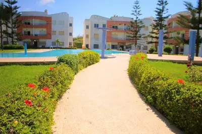 a pathway in front of a building with flowers at Mohammedia 2 in Mohammedia