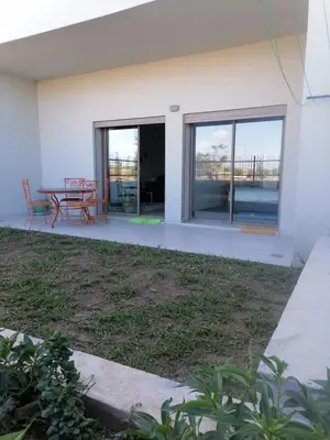 a house with a patio with a table and chairs at Zenitude in Casablanca