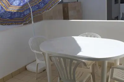 a white table and chairs in a room with a table at Paradise 11 in Pont Blondin