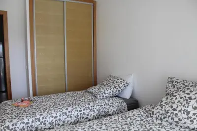 a bedroom with a bed and a pillow next to a closet at Paradise 11 in Pont Blondin