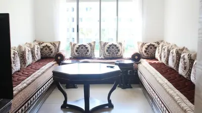 a living room with couches and a table at Paradise 7 in Pont Blondin