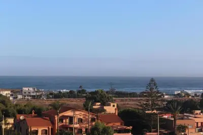 a city with houses and the ocean in the background at Paradise 7 in Pont Blondin