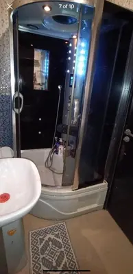 a bathroom with a shower with a toilet and a sink at الشقة دار بوعزة in Dar Bouazza