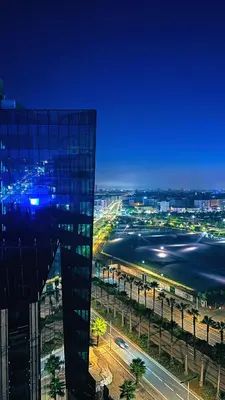 a view of a city at night with a building at Beautiful Casablanca finance city Apartment in Casablanca
