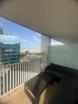a balcony with a bench and a view of a city at Beautiful Casablanca finance city Apartment in Casablanca
