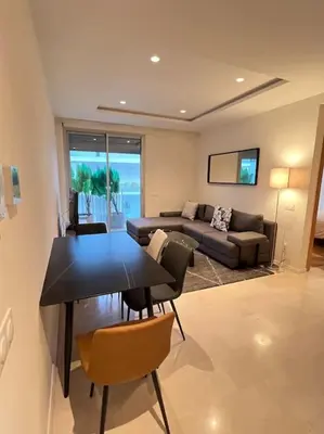 a living room with a table and a couch at Beautiful Casablanca finance city Apartment in Casablanca