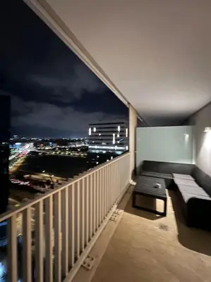 a balcony with a couch and a view of the city at Beautiful Casablanca finance city Apartment in Casablanca