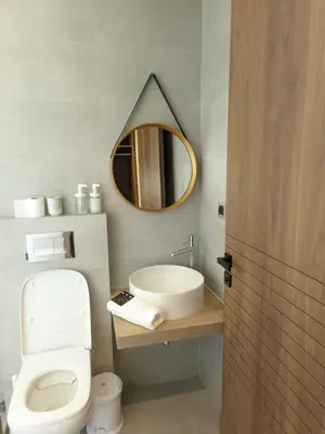 a bathroom with a sink and a toilet and a mirror at Villa Elia in Tamaris