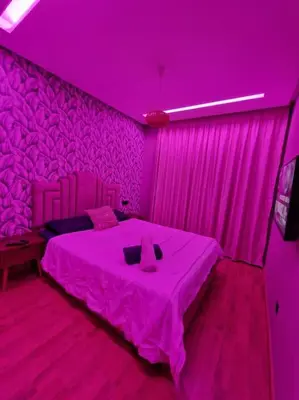 a pink room with a bed with a purple ceiling at luxury Studio with jacuzzi in Casablanca