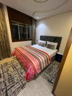 a bedroom with a large bed with a colorful blanket at Appartement vue sur mer in Casablanca