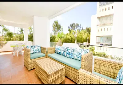 a living room with a couch and chairs on a patio at newly and fully furnished appartment in sidi rahal in Sidi Rahal