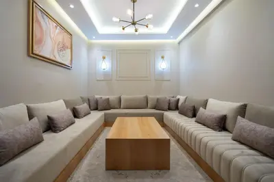 a living room with a couch and a coffee table at Appartement Élégant et Spacieux in LʼOasis