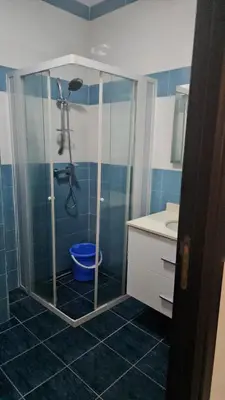 a bathroom with a shower and a toilet and a sink at Bel appartement à bouznika in Bouznika