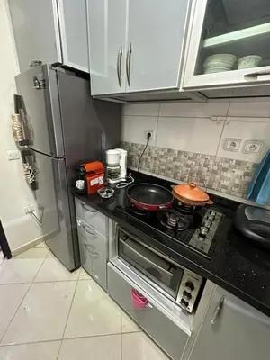 a kitchen with a stove with a frying pan on it at appartement sublime in Oulad Hamida