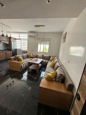 a living room with a couch and a table at Appartement Casablanca proche de la mer in Dar Mouddene