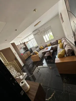 a large living room with couches and a table at Appartement Casablanca proche de la mer in Dar Mouddene
