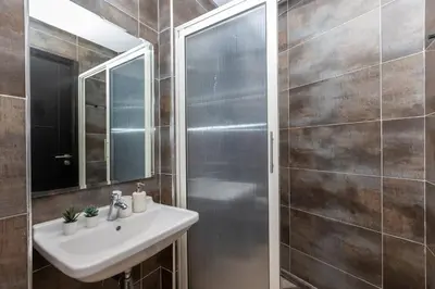 a bathroom with a sink and a mirror at Appartement Moderne au Cœur de Rabat by MERAT HOME in Océan