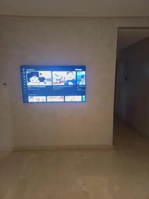 a television hanging on a wall in a room at Résidence la vallée de Californie ahfad in Le Polo