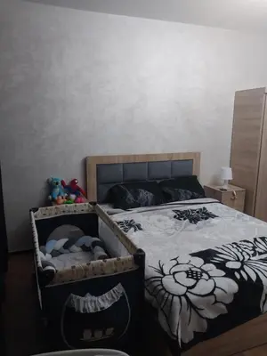 a bedroom with a bed with a comforter with flowers at Assabah apartement in Kouas