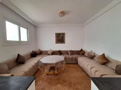 a living room with a large couch and a table at Superbe Villa Avec Piscine & Belle Vue Sur Mer in Tamaris