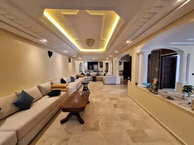 a large living room with a couch and a table at Superbe Villa Avec Piscine & Belle Vue Sur Mer in Tamaris