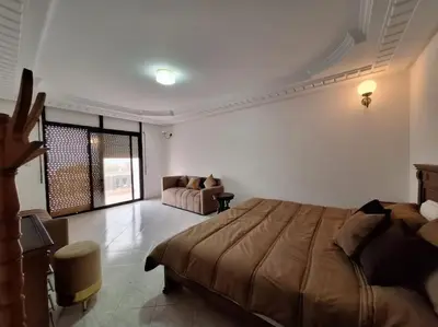 a bedroom with a bed and a couch in it at Superbe Villa Avec Piscine & Belle Vue Sur Mer in Tamaris