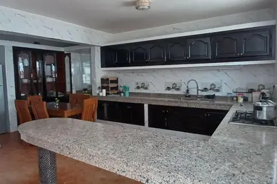 a kitchen with a granite counter top and a sink at Superbe Villa Avec Piscine & Belle Vue Sur Mer in Tamaris