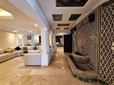 a living room with a couch and a tub on the wall at Superbe Villa Avec Piscine & Belle Vue Sur Mer in Tamaris