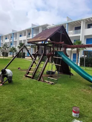 a playground in a park with a slide at Très bel Appartement avec Piscine et Jardin in Mansouria