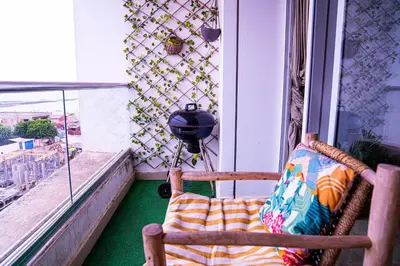a chair sitting on a balcony looking out a window at Beautiful and Stylish 2BR Appartment with a wide Beach View in Mohammedia