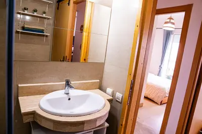 a bathroom with a sink and a mirror at Beautiful and Stylish 2BR Appartment with a wide Beach View in Mohammedia