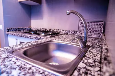 a kitchen sink with a faucet on a counter at Beautiful and Stylish 2BR Appartment with a wide Beach View in Mohammedia