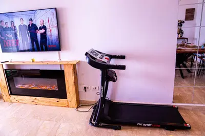 a room with an exercise bike next to a fireplace at Beautiful and Stylish 2BR Appartment with a wide Beach View in Mohammedia
